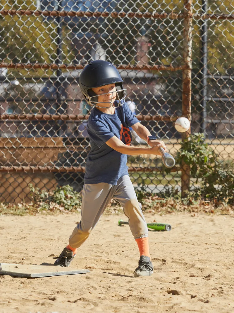 Original photo of a young baseball player swinging a bat