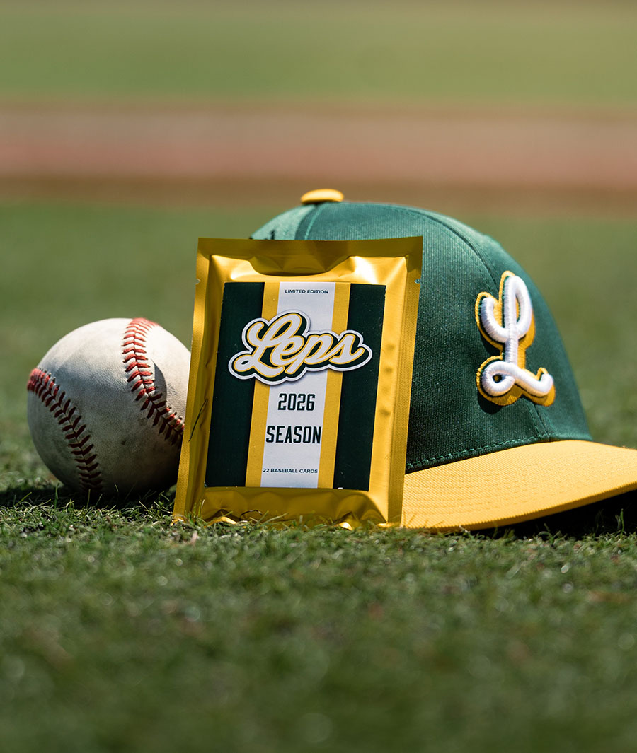 Foil card pack for the Royal Oak Leprechauns resting against a baseball and cap